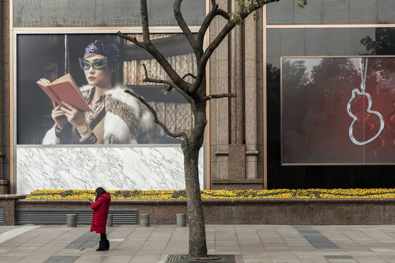 Street with woman in front of windowdisplay
